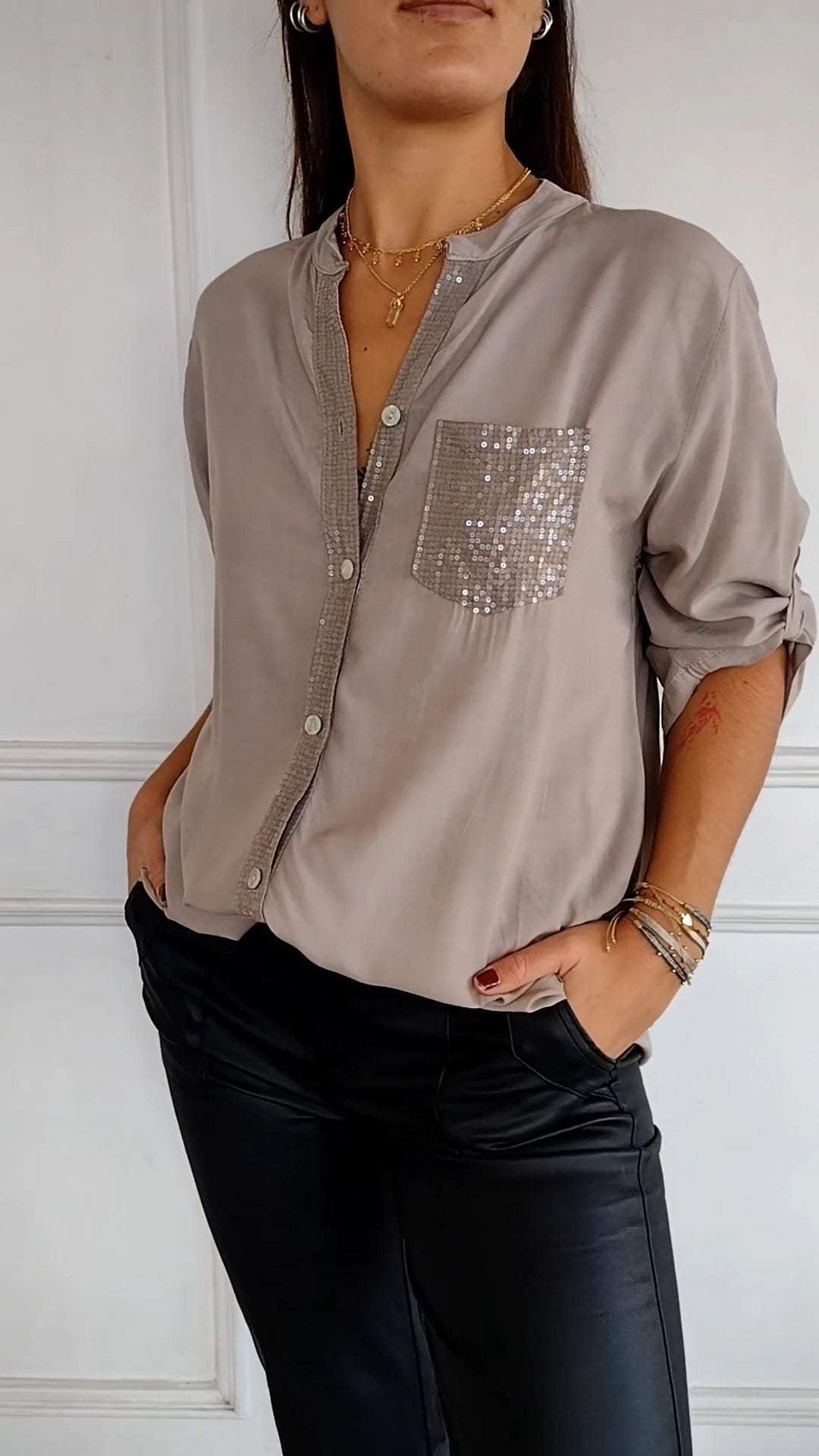 Sparkly women's shirt with sequin trim on a classic button-up design, very glam.