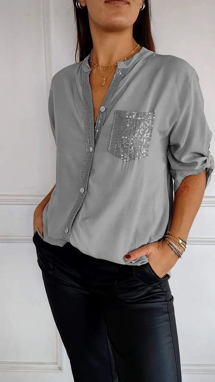Sophisticated women's shirt with sequin detailing and button closure, a trendy blouse.