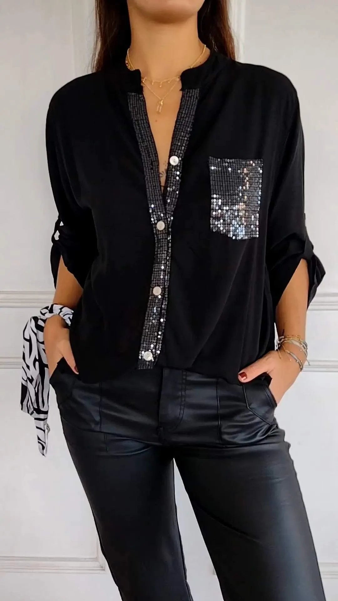Women's button-down shirt with dazzling sequin embellishments for a sparkly touch.