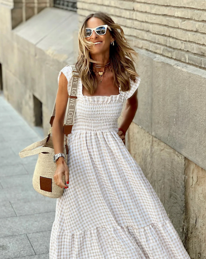 Flowy women's smocked maxi dress, offering elegant style and casual comfort for any summer occasion.