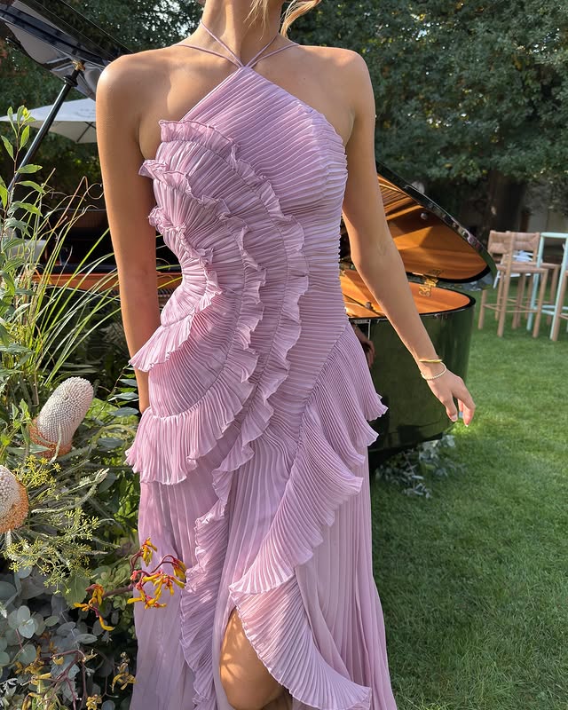 Full-length view of an elegant strapless ruffle maxi dress, perfect for a wedding guest or formal party.
