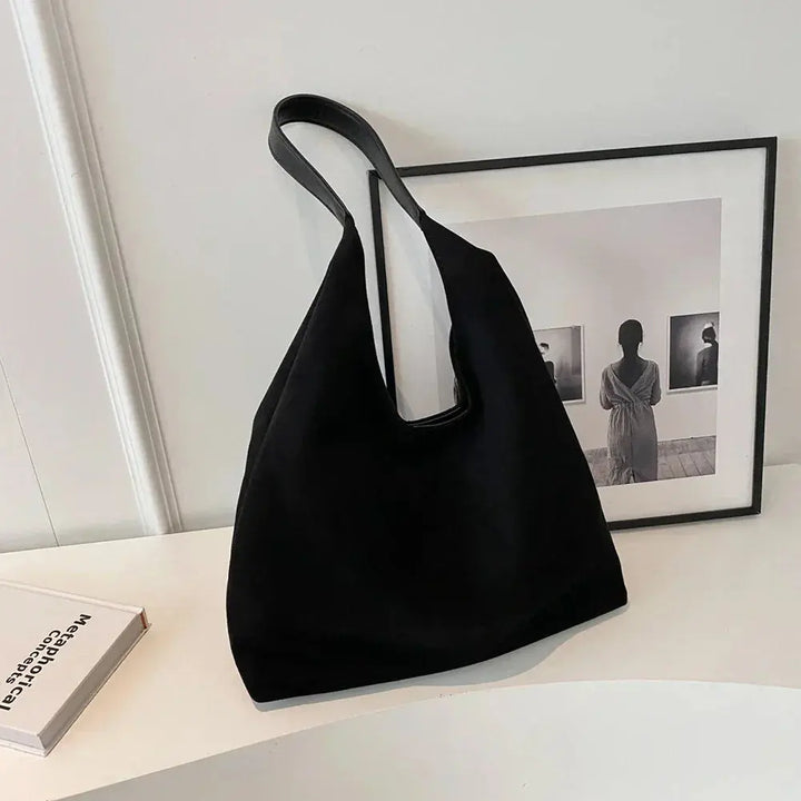 Spacious women's suede tote bag, an elegant shoulder handbag for daily essentials.