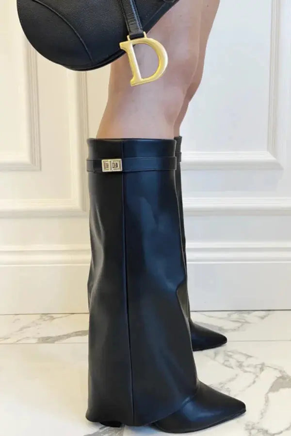 Close-up on stitching and craftsmanship of women's elegant tall boots.