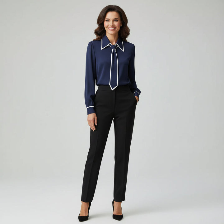 Close-up of a women's elegant tie-neck blouse, showcasing detailed craftsmanship and soft fabric.
