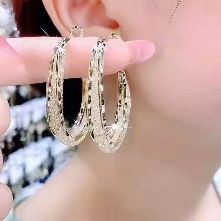Sparkling crystal twisted oval hoop earrings for women, perfect for an elegant statement.