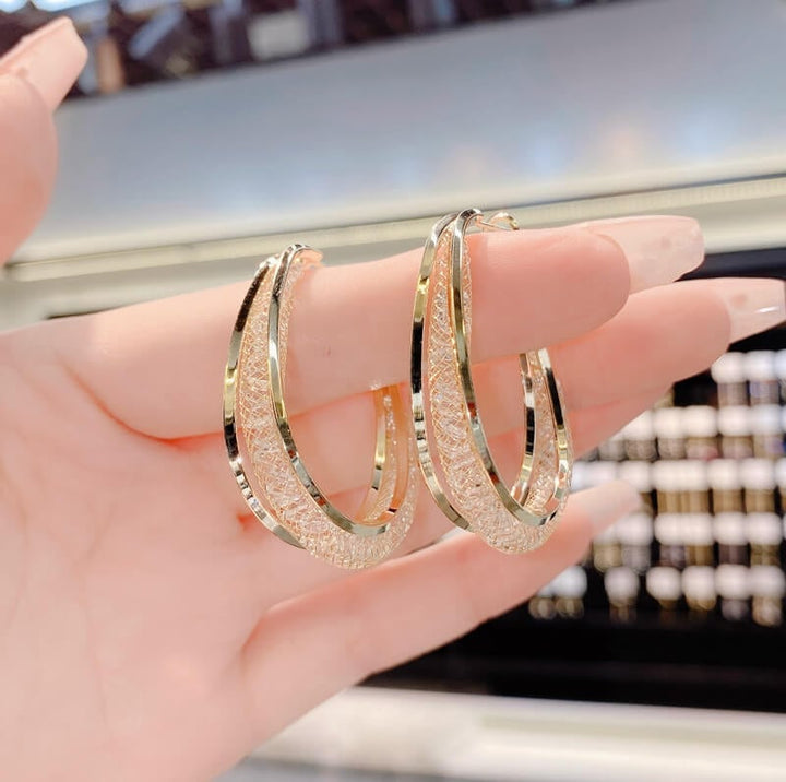 Brilliant crystal twisted oval hoops, dazzling women's jewelry, a fashionable accessory.