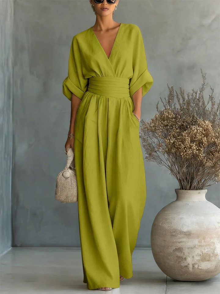Back view of an elegant women's V-neck jumpsuit. Versatile one-piece for day to evening comfort.