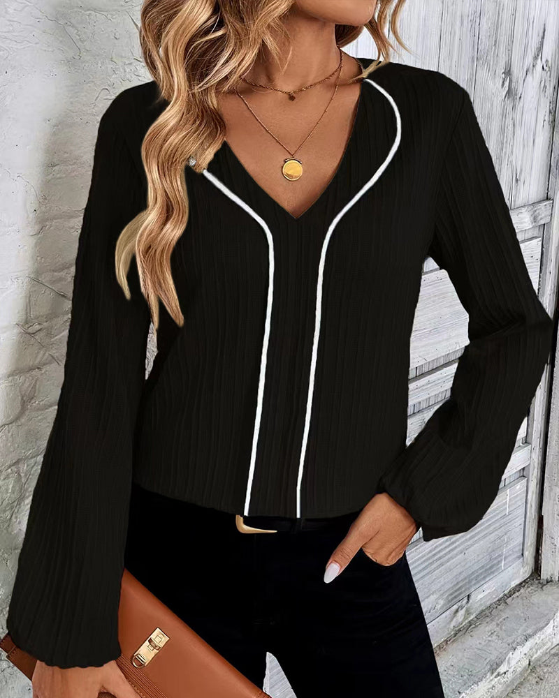 Elegant women's V-neck top, full balloon sleeves. A chic, versatile blouse for sophisticated everyday fashion.