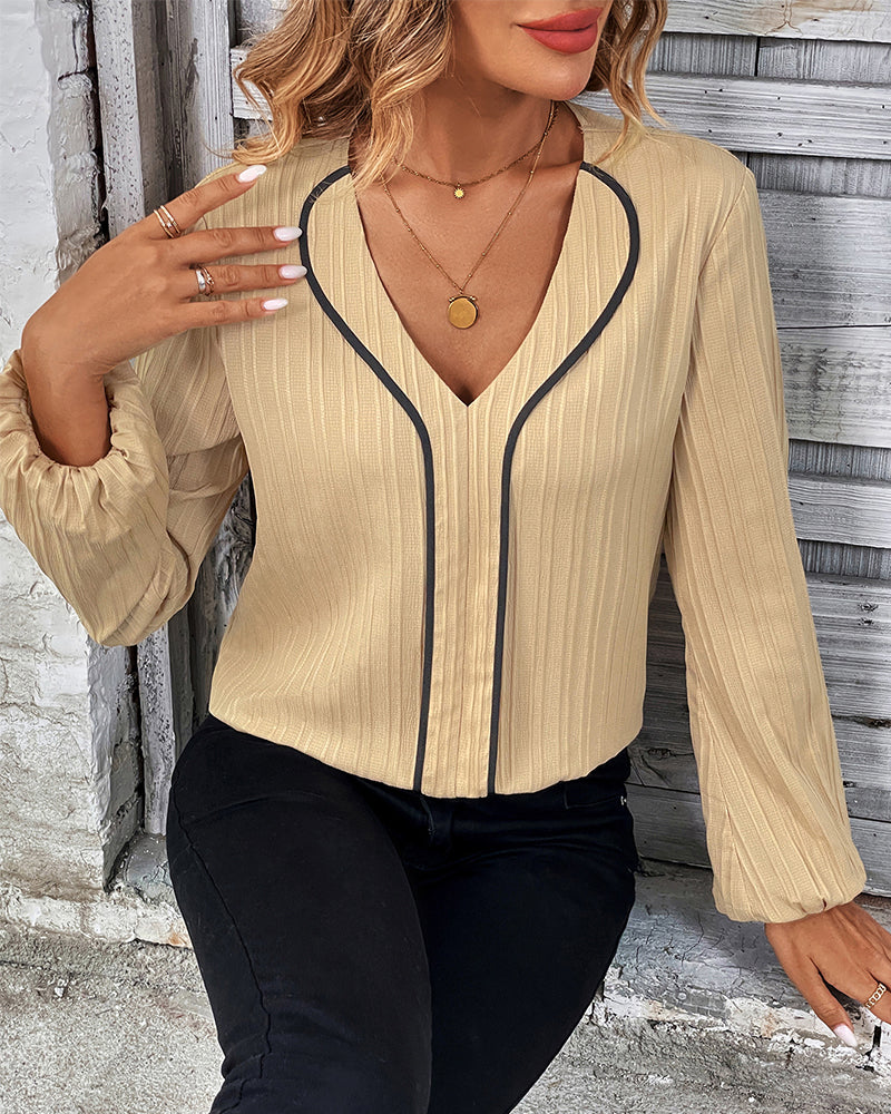 Professional women's V-neck long sleeve blouse with stylish balloon sleeves. Ideal office wear or smart casual top.