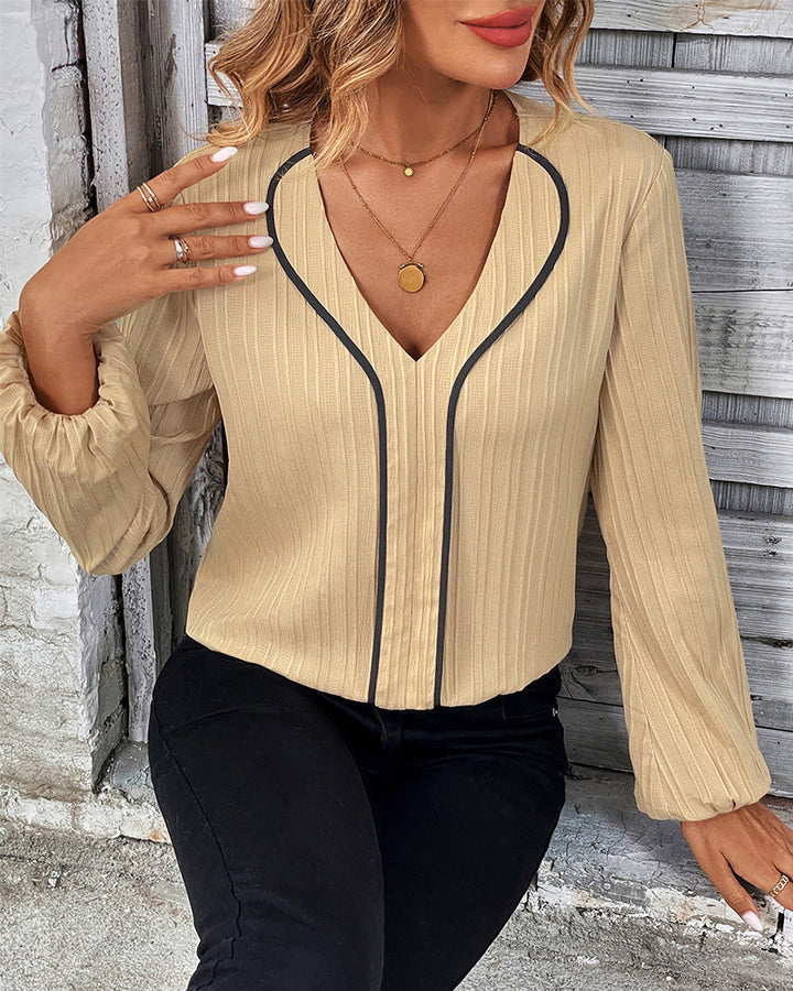 Professional women's V-neck long sleeve blouse with stylish balloon sleeves. Ideal office wear or smart casual top.