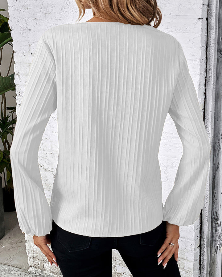 Fashionable women's long sleeve V-neck top with elegant balloon sleeves. A chic and versatile blouse.
