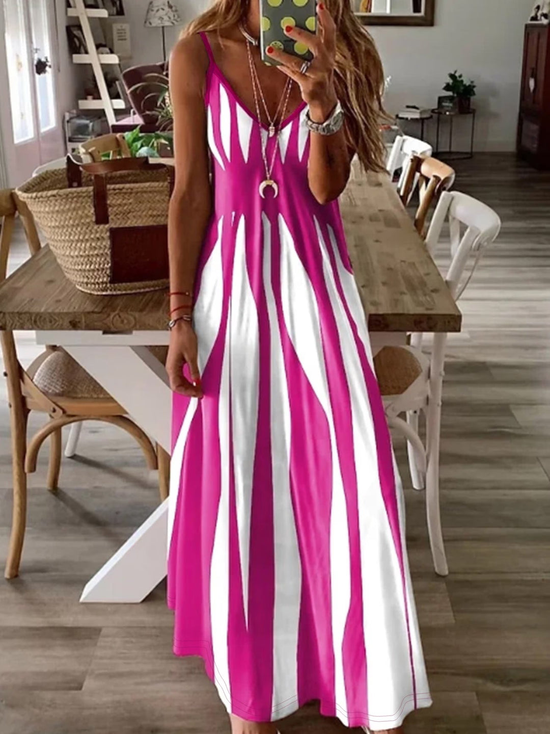 Stylish women's V-neck summer dress, features thin straps & flowing fabric. Comfortable, flattering, perfect for warm days.