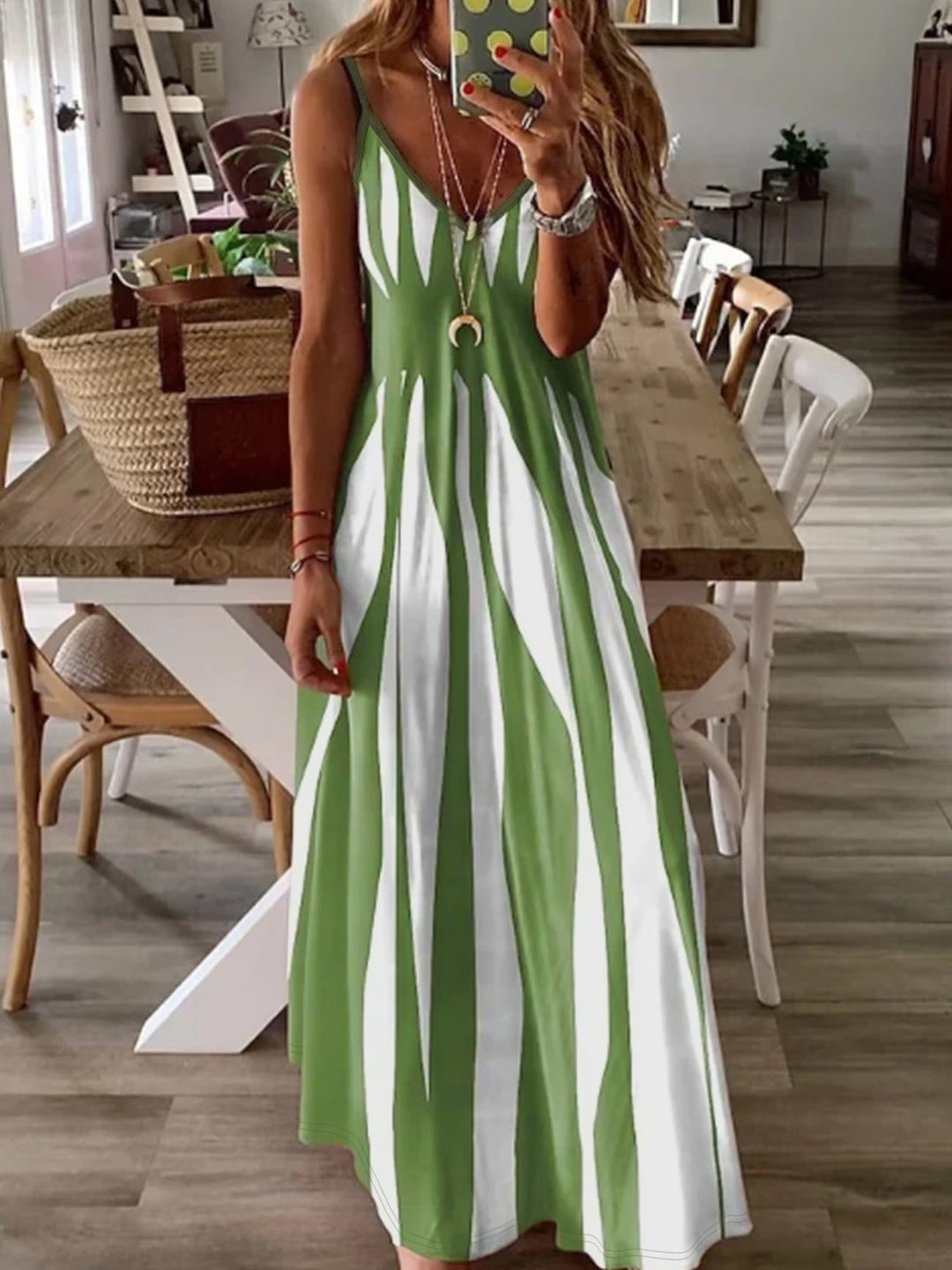 Chic women's V-neck summer dress with thin straps, offering a flattering, flowing silhouette for elegant casual wear.