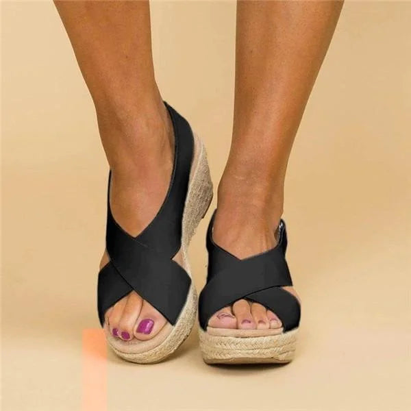 Women's elegant wedge sandals in tan leather, perfect for summer style.