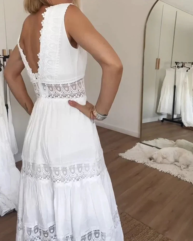 White bohemian tiered midi dress for women, featuring a flattering V-neck, sleeveless cut, and flowy lace details.