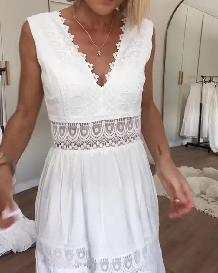 Flowy white boho midi dress for women, elegant and sleeveless with a V-neck, ideal for summer parties & casual wear.