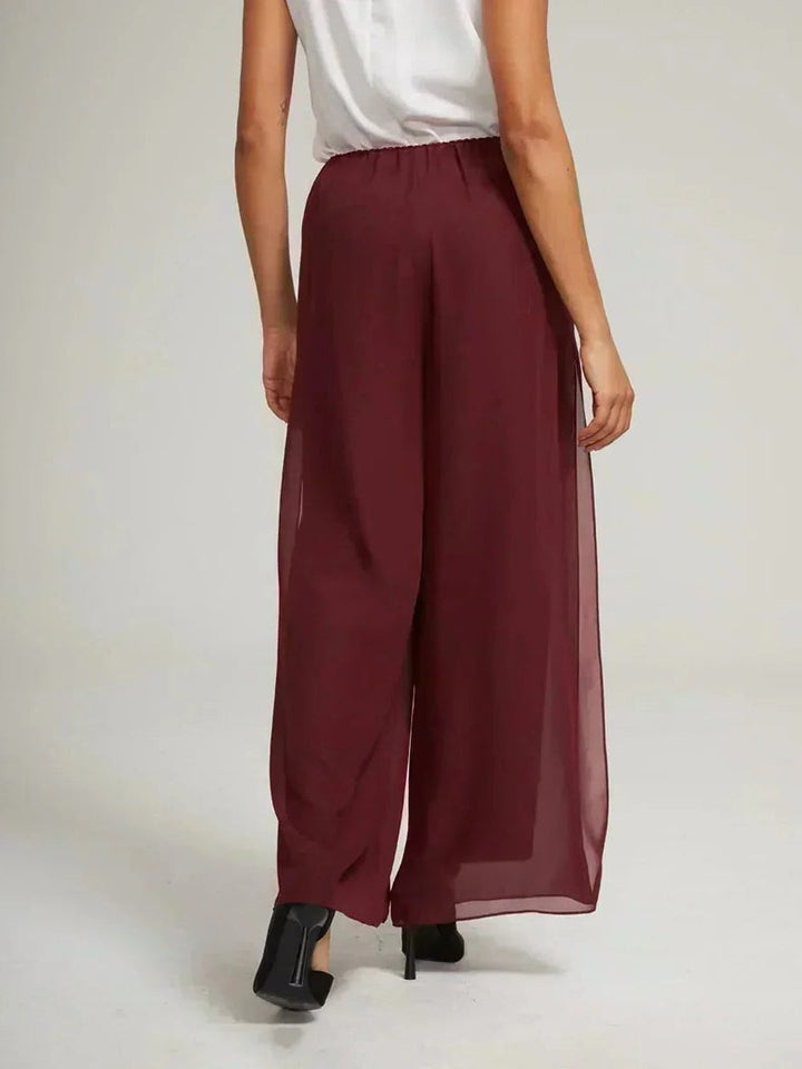 Stylish women's wide leg trousers with a tie waist, offering elegant comfort.