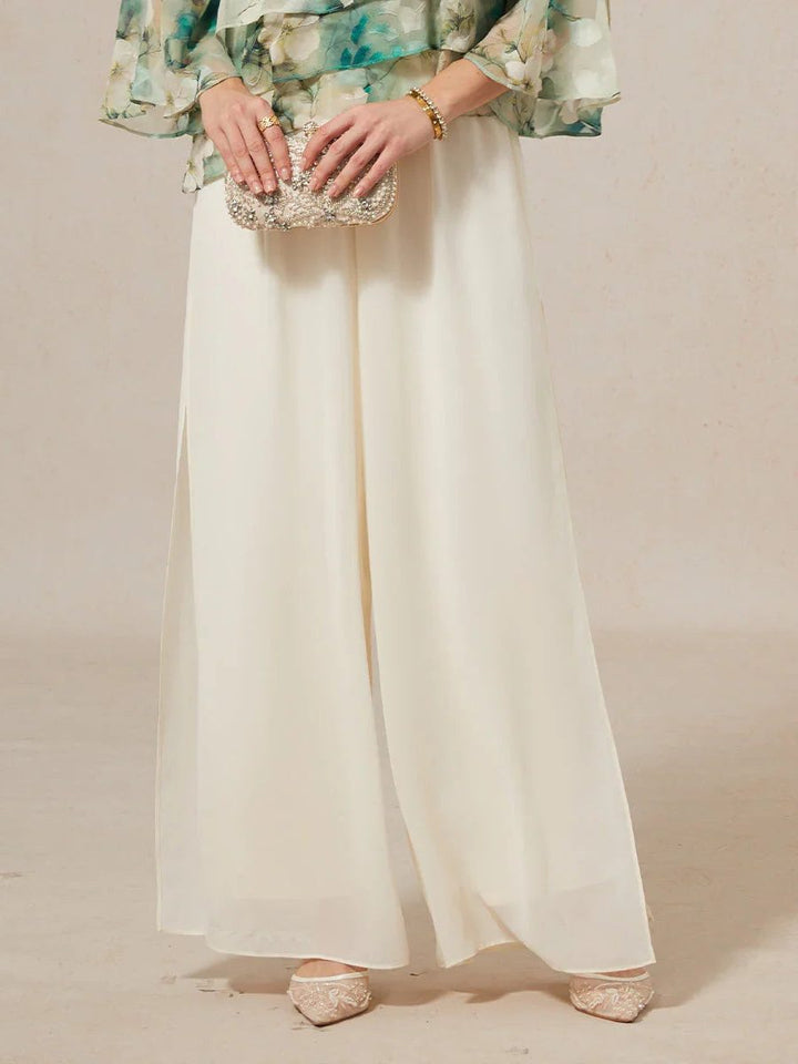 Flowy women's wide leg trousers with a chic tie waist, combining elegance and comfort.
