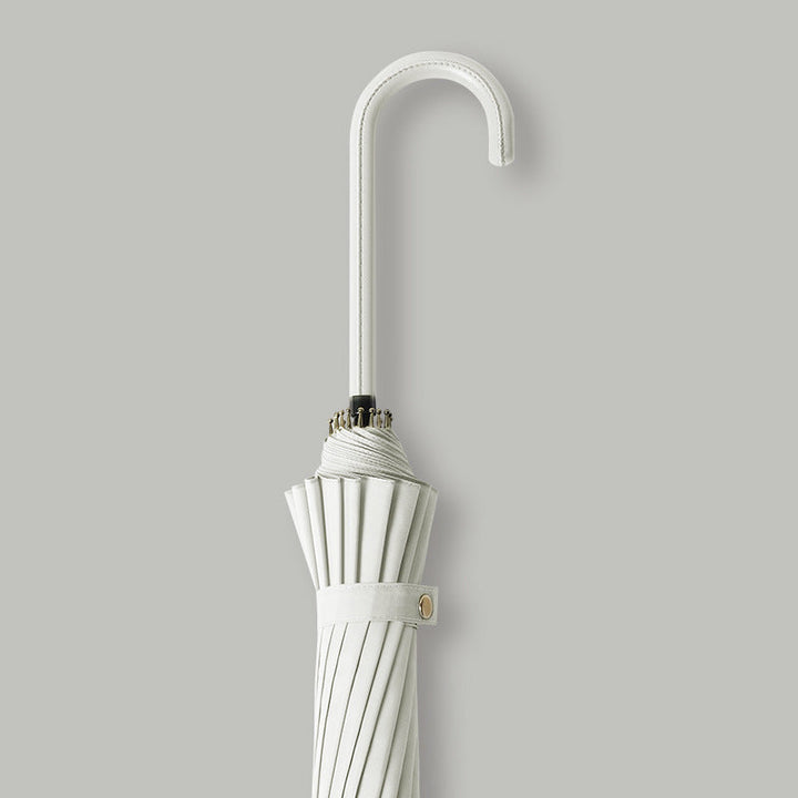Close-up of elegant women's automatic umbrella, showing durable windproof canopy texture.