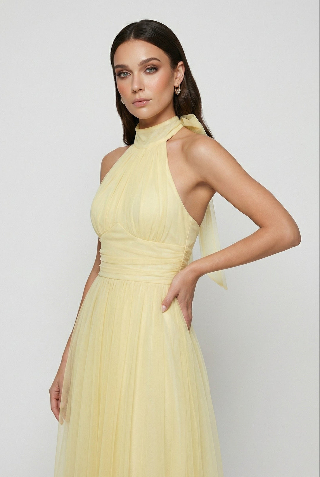 Chic yellow sleeveless midi dress with a sophisticated high neck, ideal for casual outings.