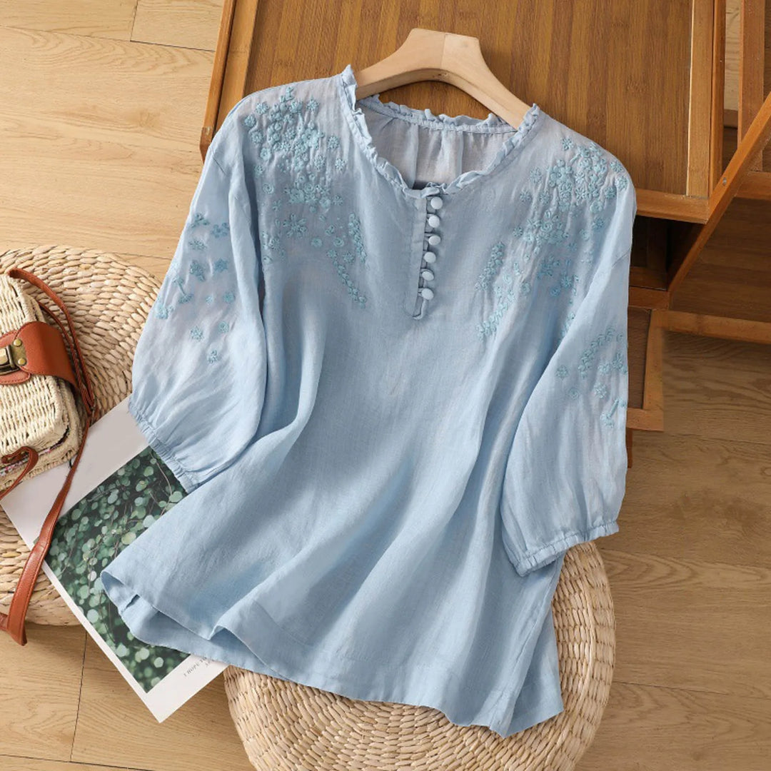 Chic women's boho tunic blouse, relaxed fit, featuring elegant floral embroidery and a stylish button front.