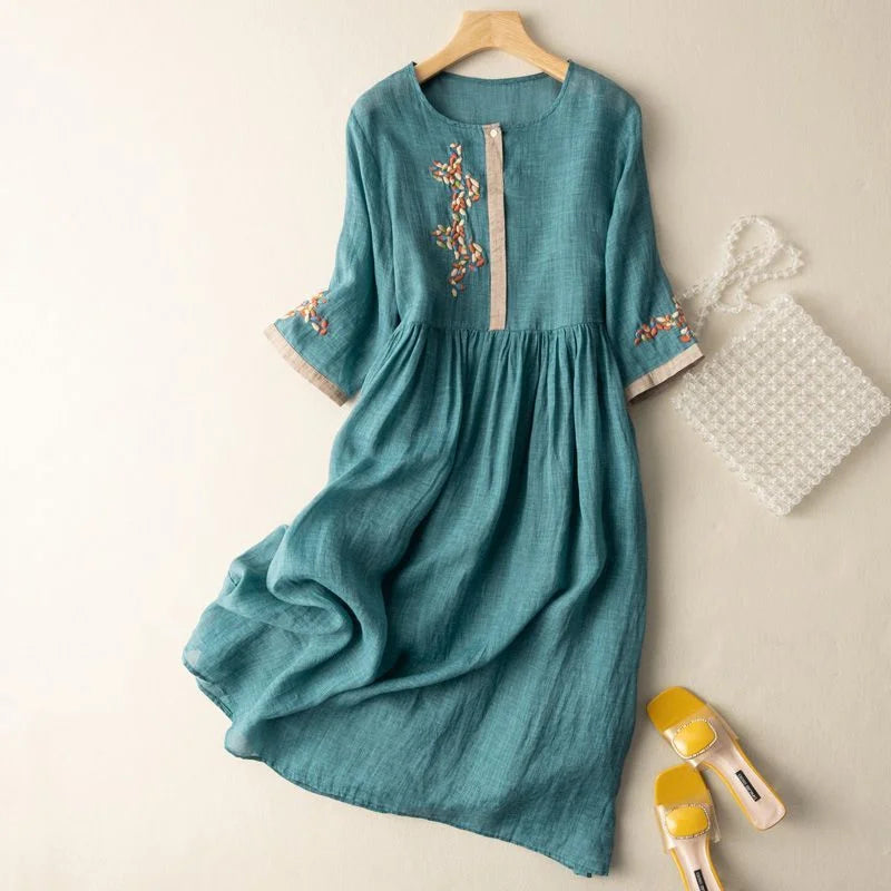 Women's embroidered midi dress with 3/4 sleeves and relaxed fit for summer comfort. Features delicate detailing.