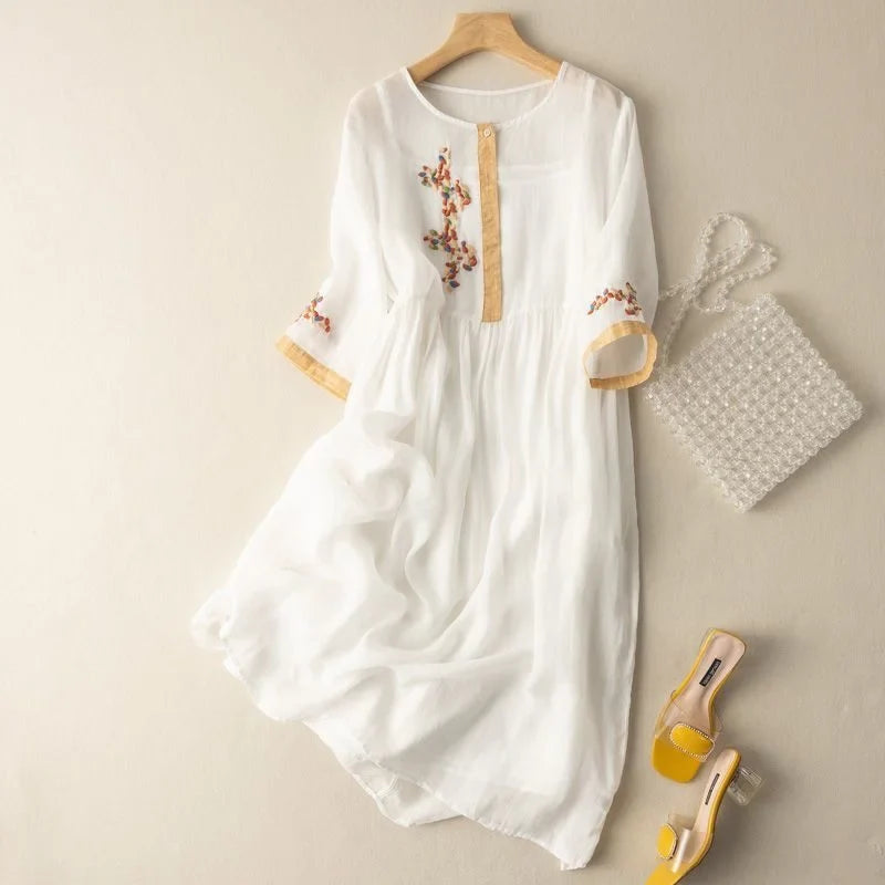 Flowy women's midi dress with intricate embroidery, 3/4 sleeves, and relaxed fit. Perfect for casual elegance.