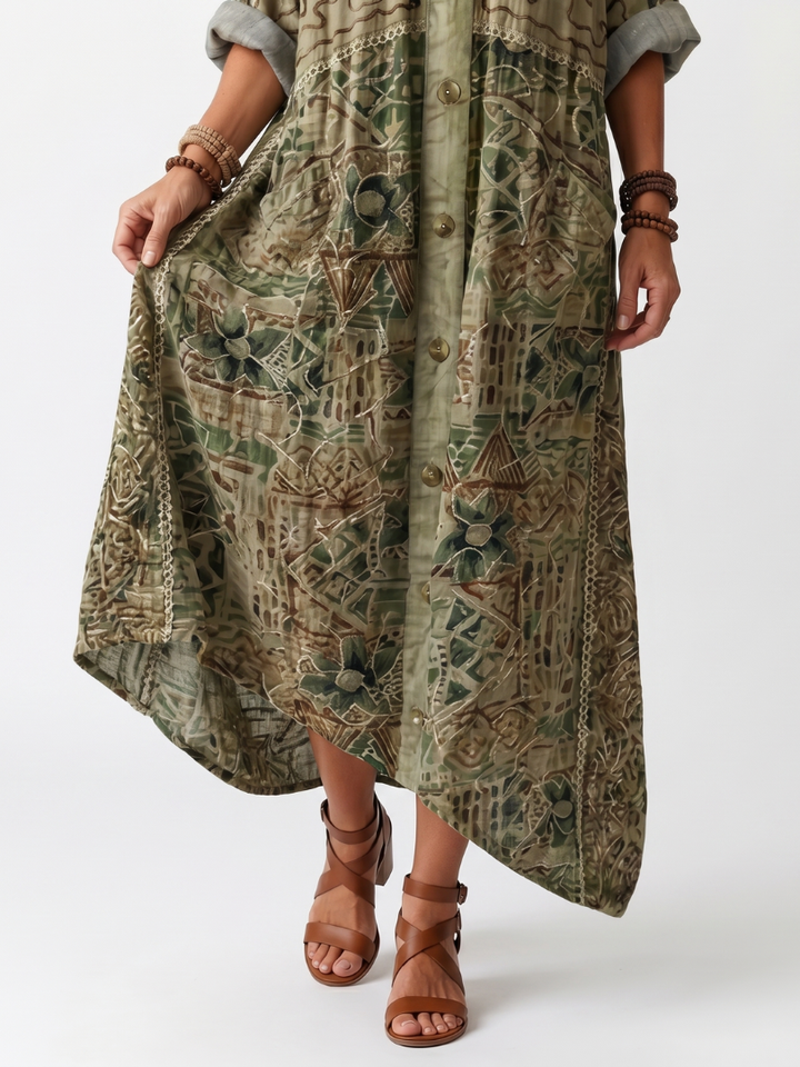 Casual women's midi dress with intricate embroidery, a classic button front, and convenient side pockets.