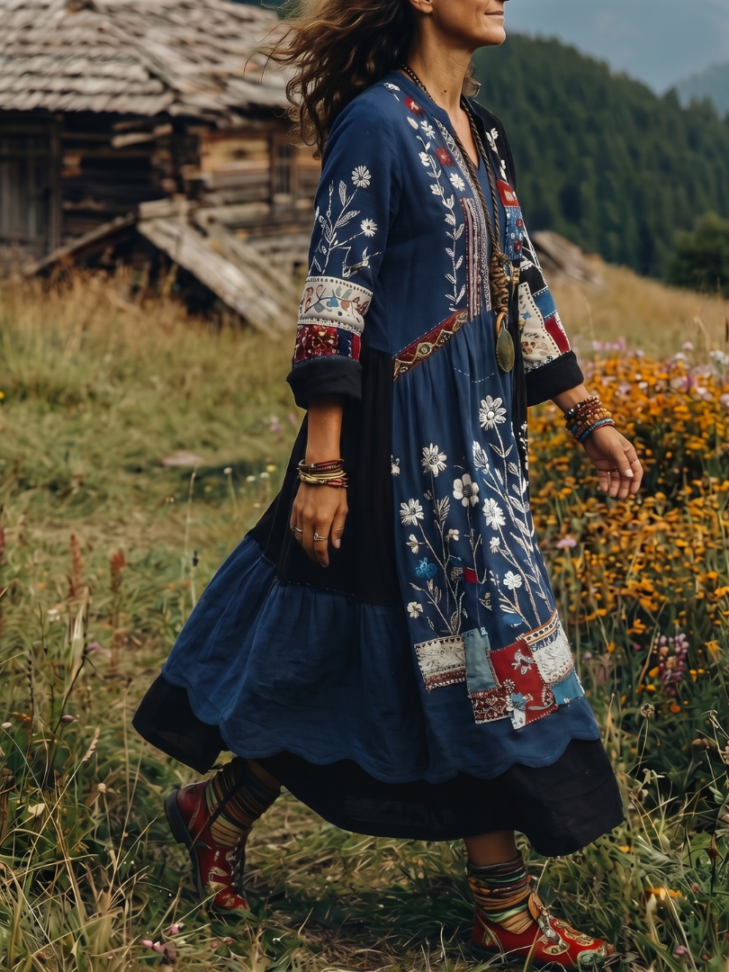 Back view of a women's modest fashion embroidered midi dress with long sleeves and flowing design.