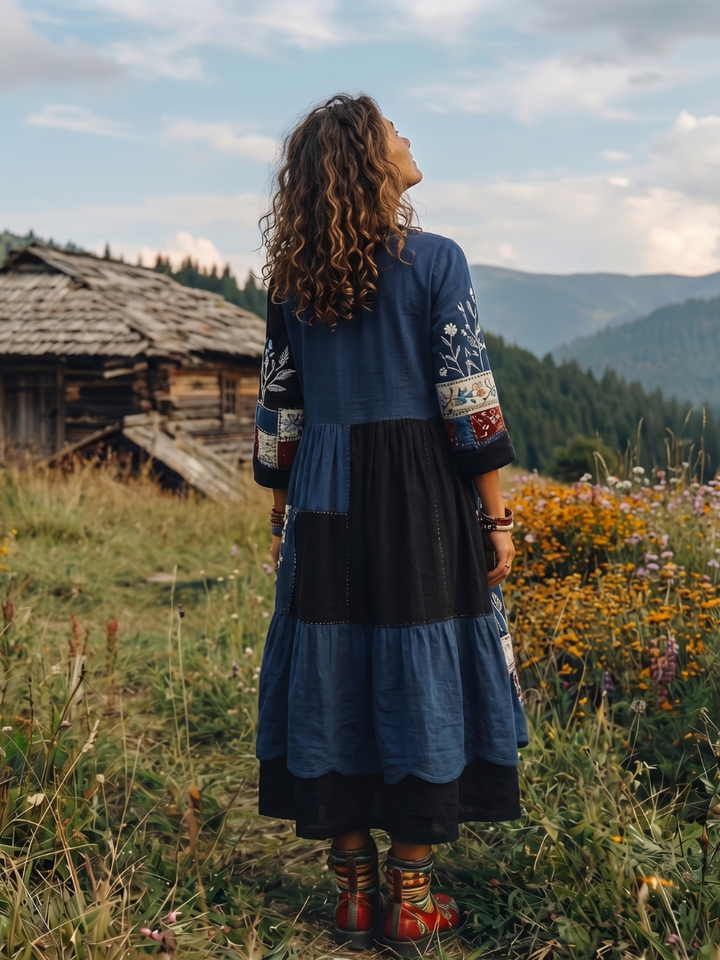 Textured detail of soft fabric on a comfortable long sleeve midi dress with an embroidered panel.