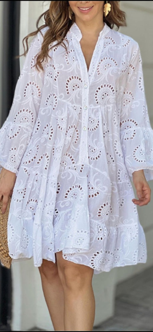 Flowy A-line mini dress with intricate embroidery, tiered skirt, and stylish bell sleeves. Ideal casual summer dress.