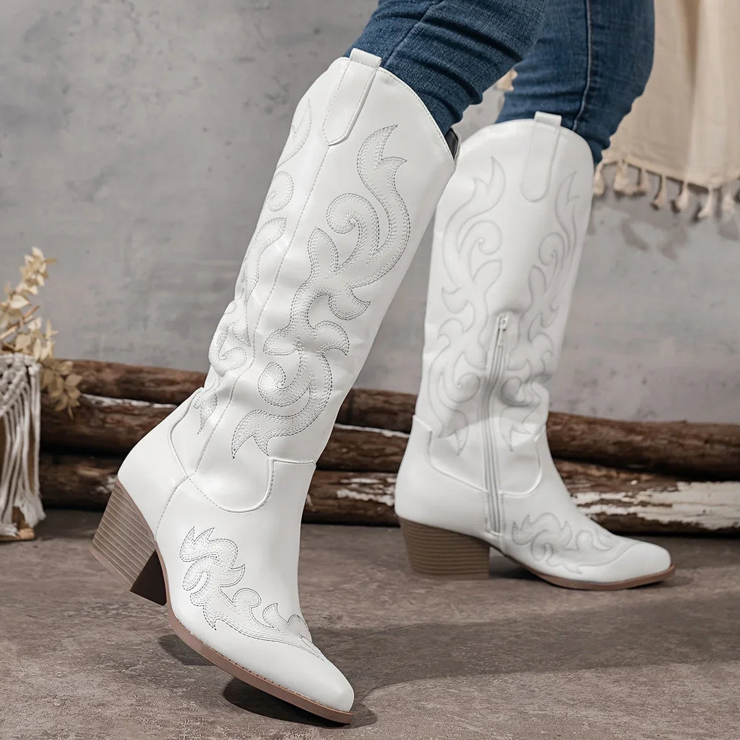 Detailed embroidery adorns these women's knee-high western boots, complete with a block heel.