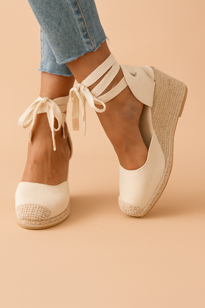 Women's espadrille wedge sandals with adjustable ankle ties for a secure fit.