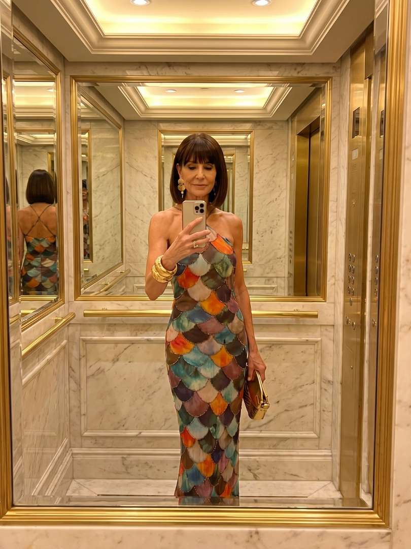 Sophisticated women's sleeveless maxi dress, vibrant multicolor scale pattern. A fitted party dress with geometric flair.