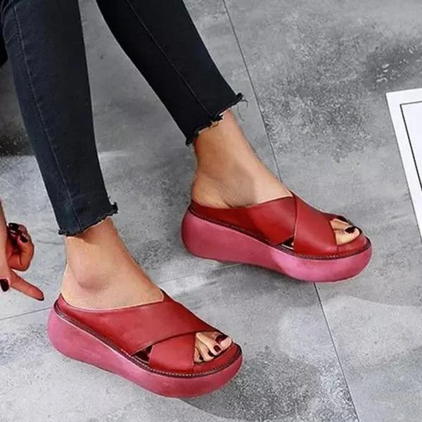 Versatile women's flat sandals with soft cushioning, sophisticated cross-straps, and a comfortable open-toe design.