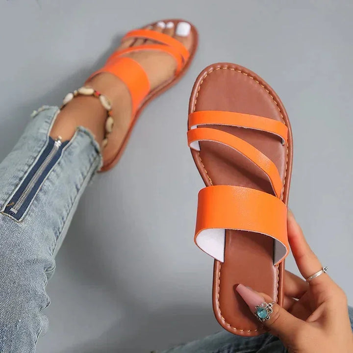 Versatile women's flat slip-on sandals, cushioned multi-strap and open-toe for maximum summer comfort.