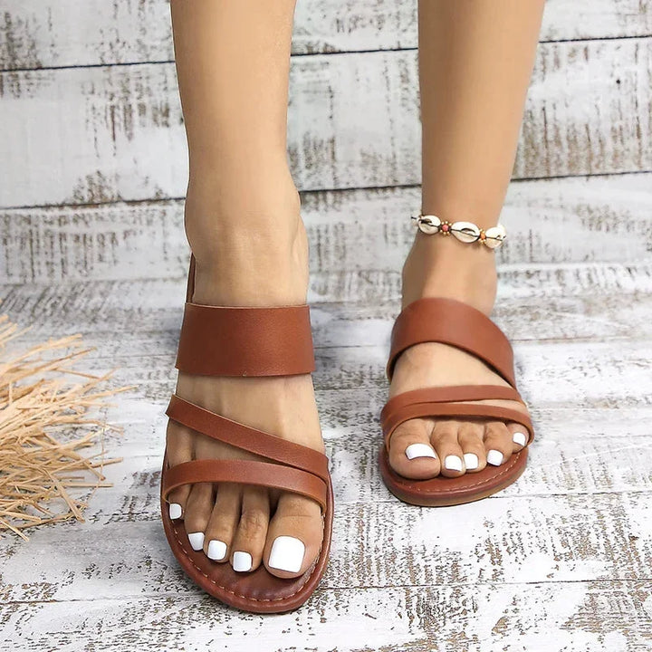 Women's open-toe flat multi-strap sandals, cushioned for comfort, easy slip-on, ideal for casual summer.