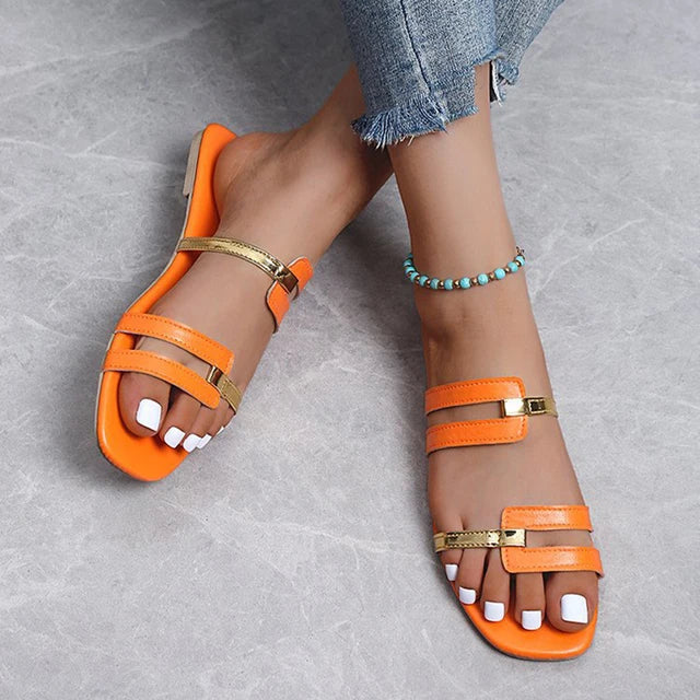 Comfortable women's flat sandals. Open-toe slides with chic double straps & elegant gold accent.