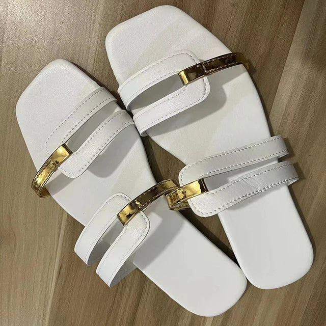 Summer women's flat sandals. Trendy double strap, open toe design with eye-catching gold detail.
