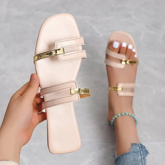 Chic women's flat slides. Gold detailed double straps, open toe, perfect for casual summer wear.