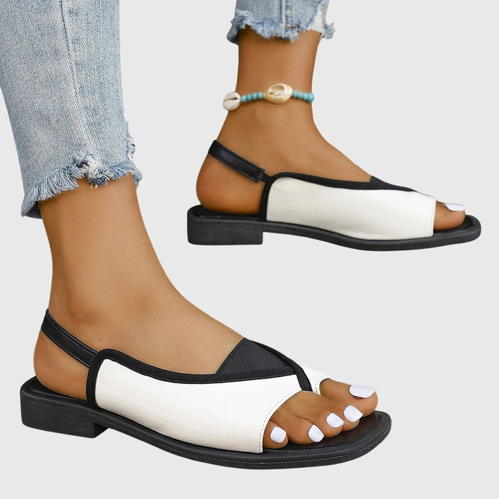 Stylish women's slingback flat sandals featuring a chic contrast trim, perfect for summer beach & casual outfits.