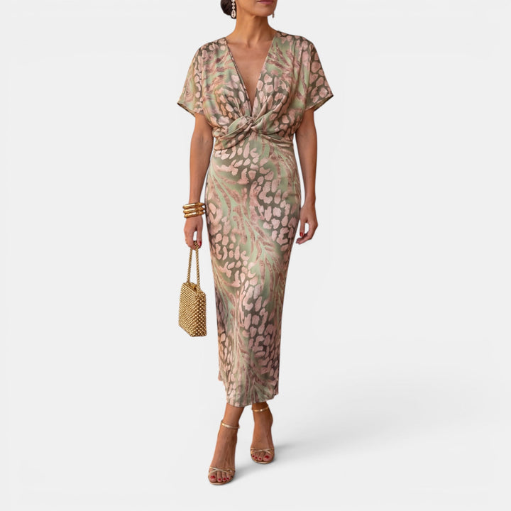 Women's flattering apricot midi dress with defined twist waist, perfect for elegant occasion wear.
