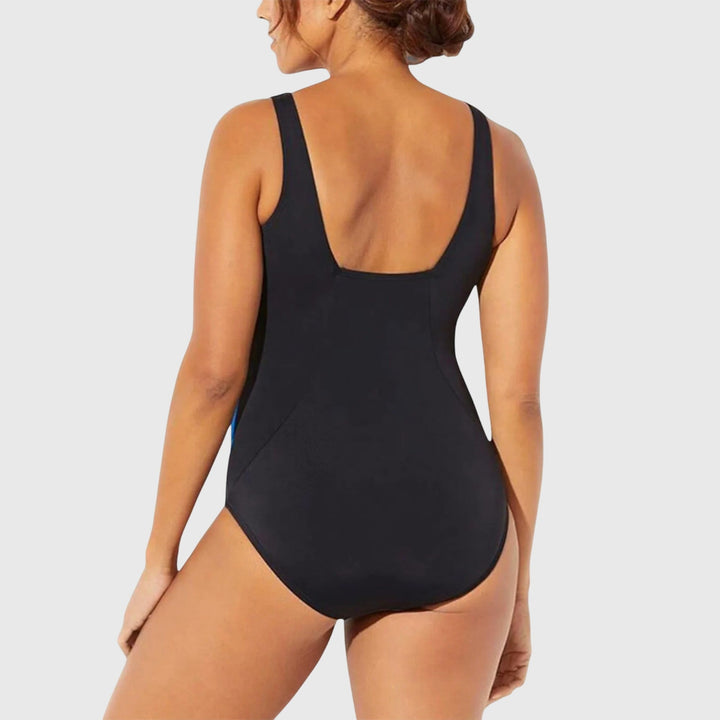 Stylish women's shaping one-piece swimsuit with vibrant print, perfect for poolside comfort.