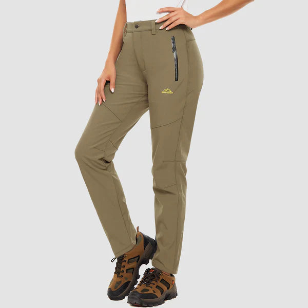 Durable, windproof hiking apparel: cozy fleece-lined waterproof pants for women's outdoor adventures.