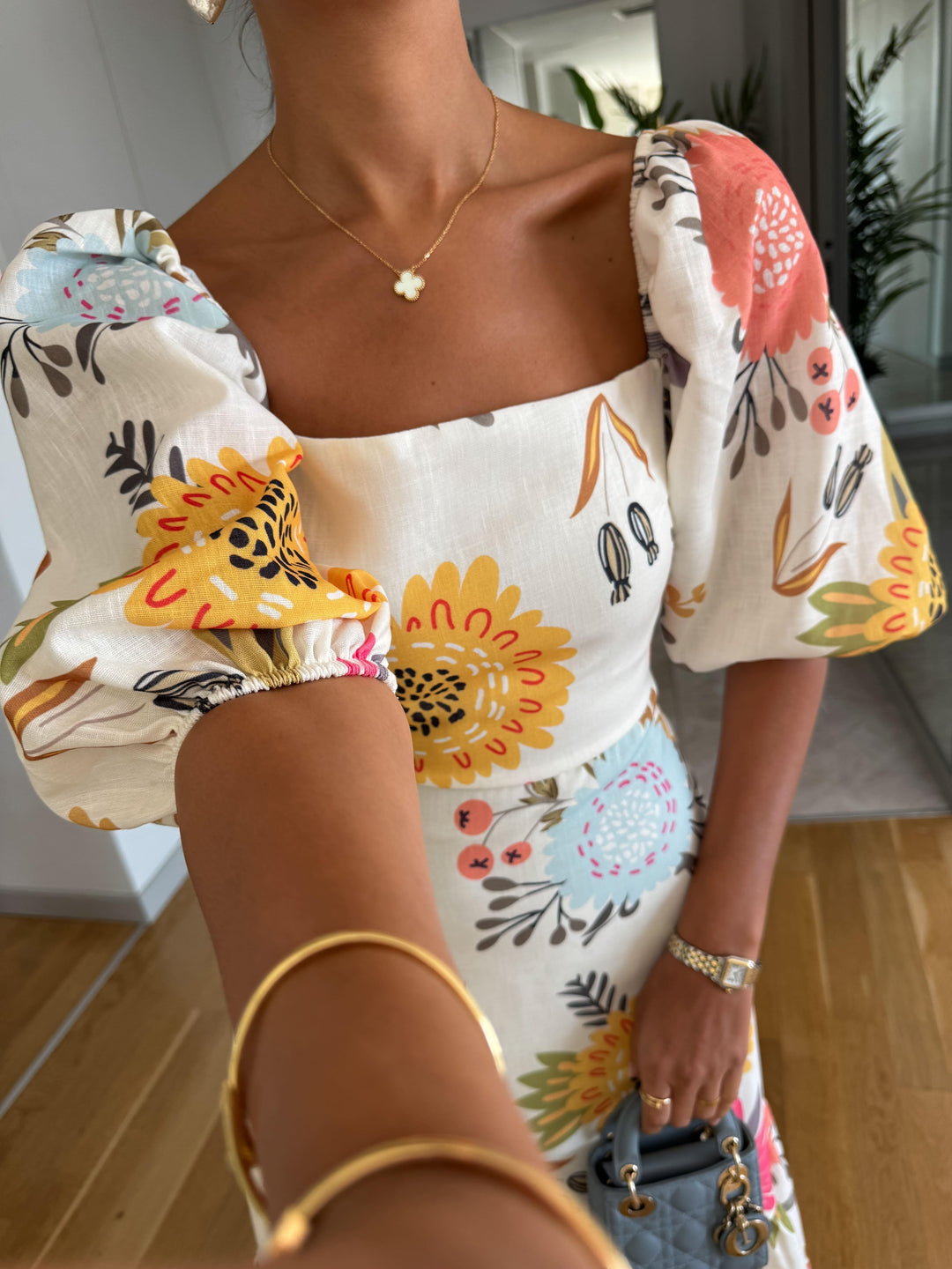 A-line floral midi dress designed with trendy puff sleeves, ideal for casual outings or date nights.