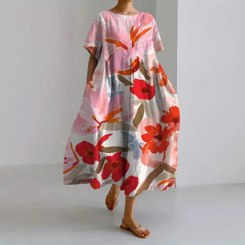 Vibrant floral A-line midi dress for women, featuring a round neck & short sleeves. Ideal spring/summer fashion.