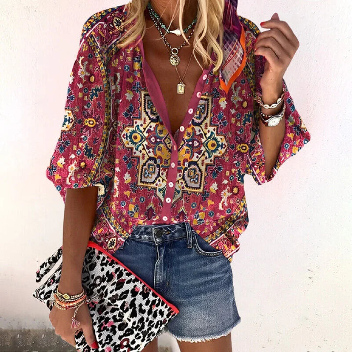 Relaxed women's floral print V-neck blouse, bohemian style with comfortable 3/4 sleeves for casual wear.