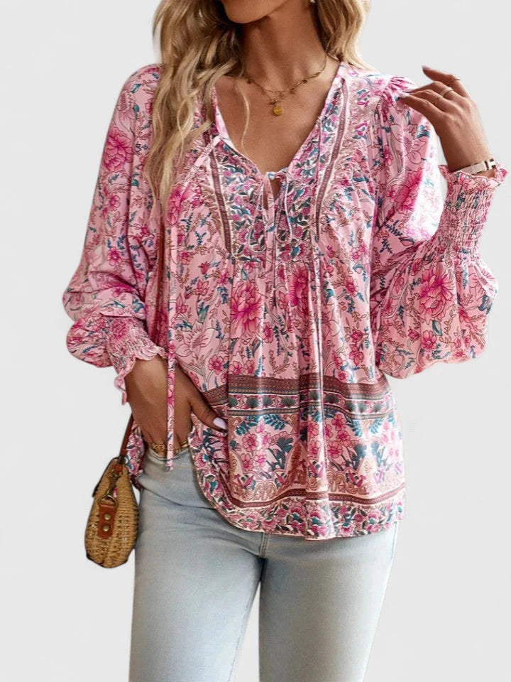 Women's floral boho V-neck blouse with smocked puff sleeves, perfect for spring fashion.