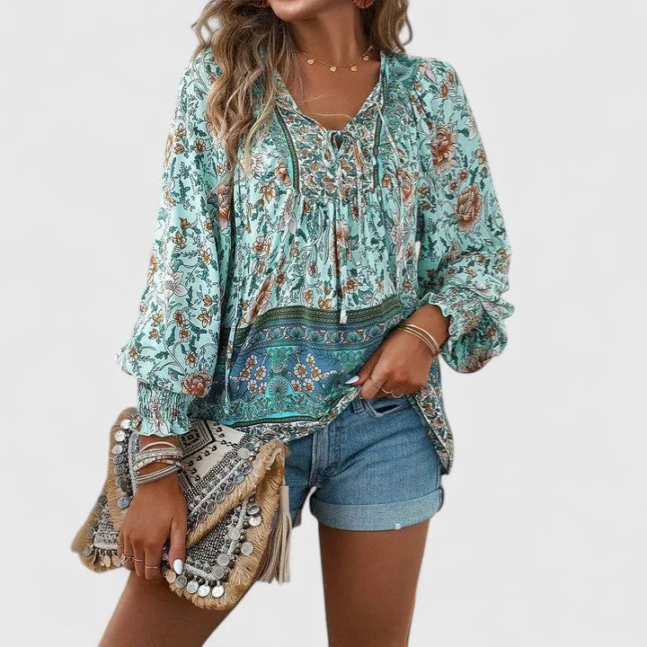 Chic women's spring blouse: floral botanical print, relaxed fit, V-neck, and smocked puff sleeves.