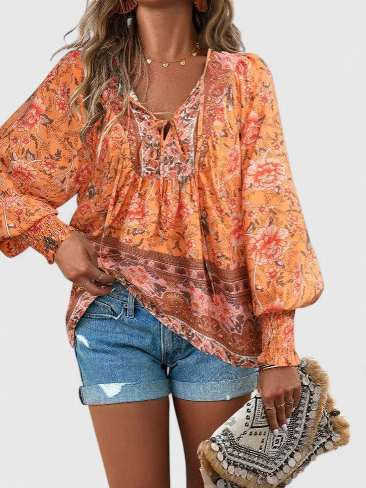 Relaxed fit women's floral boho top, with a flattering V-neck tie and trendy smocked puff sleeves.